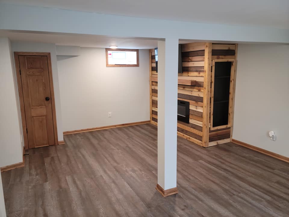 Wide view of custom media wall in a finished basement