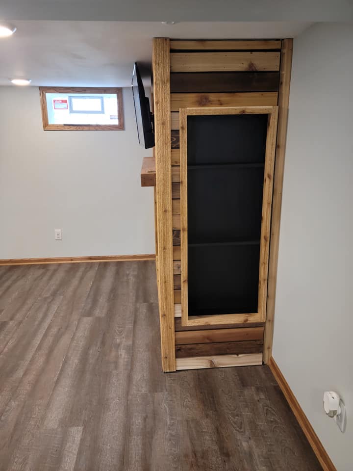 Concealed doorway built into a custom wood media wall