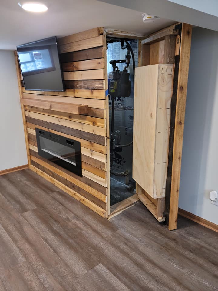 Hidden door opened beside a custom fireplace media wall